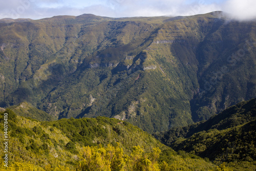 Obraz na płótnie Explore the breathtaking landscapes of Madeira with its stunning mountain ranges and lush green valleys under a clear blue sky w salonie