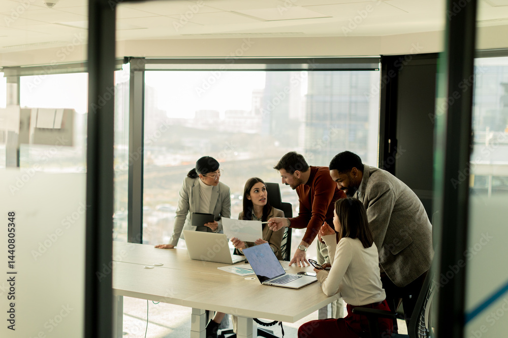 Collaboration among diverse professionals in modern office space during a strategic meeting