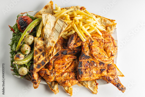 Grilled Chicken with French Fries, Flatbread, and Vegetables on a Plate Isolated on White Background

