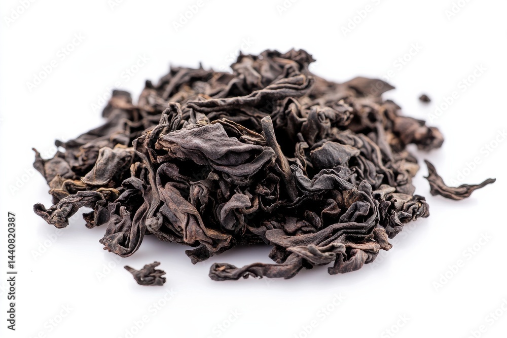 A Pile of Dark, Wrinkled Tea Leaves: A close-up shows the intricate textures of dried tea leaves, ready for steeping in a warm cup. A Pile of Dark, Wrinkled Tea Leaves: A close-up shows the intricate textures of dried tea leaves, ready for steeping in a warm cup.