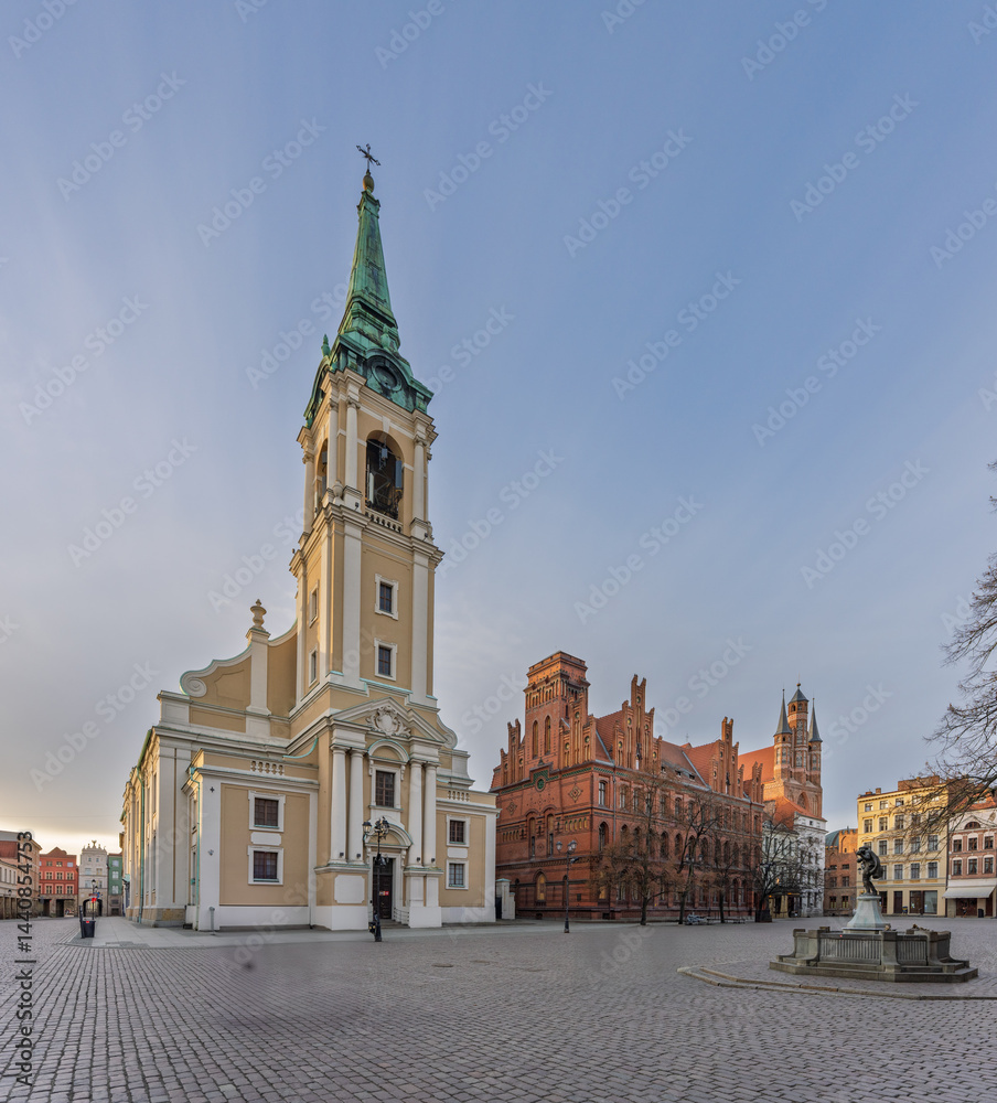 Fototapeta premium St. Mary's Church tower seen between historic townhouses in Toruń, Poland..