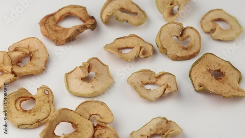 Dried apple slices arranged on a plain surface highlighting their natural textures and shapes