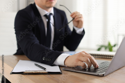 Professional banker working at desk in office, closeup