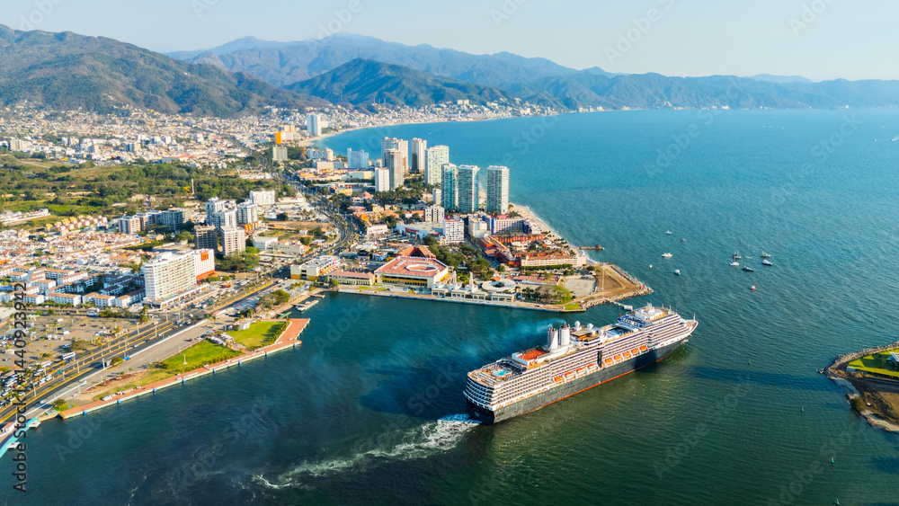 Obraz premium Huge cruise ship dominating the city skyline at sunset. Puerto Vallarta, Jalisco. Mexico