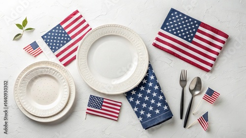 Table setting with white plates, silverware and american flag napkins on textured white surface, concept of festive patriotism and celebration
