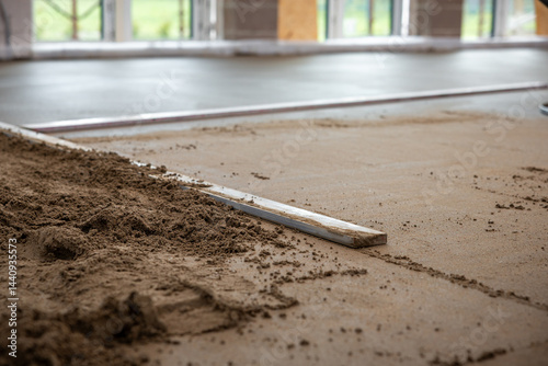 Obraz na płótnie Construction site interior showing underfloor heating pipes being installed and covered with screed concrete. Natural light enters through large windows. w salonie