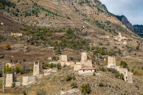 Obraz na płótnie Ancient stone towers and buildings in mountainous landscape. Ruins of old village built into hillside. North Caucasus mountainous Ingushetia Russia Historical ruins in mountainous landscape. w salonie
