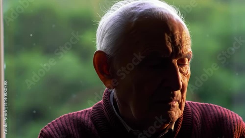 Elderly Man Looking out Window on Rainy Day Close-up