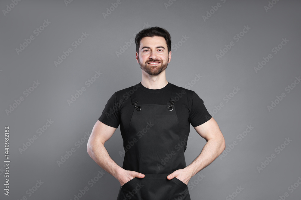 Naklejka premium Portrait of smiling barista on grey background