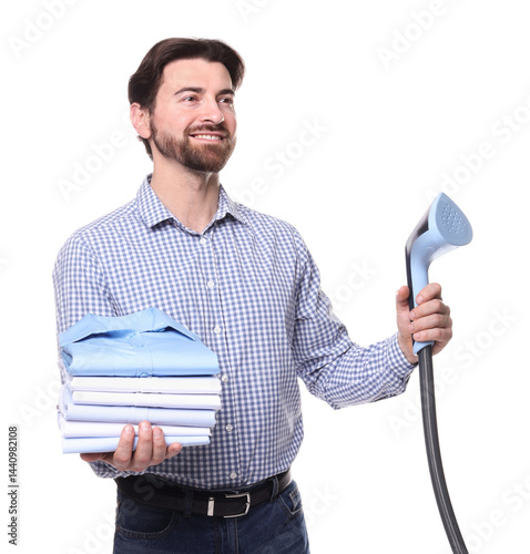 Man with stand steamer and stack of clothes on white background