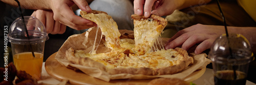 Foto Group of friends enjoying and sharing cheese pizza with gooey melting cheese and
