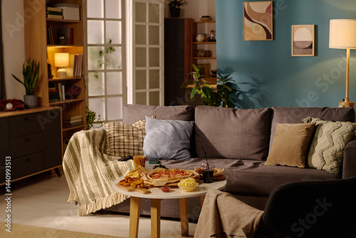 Konstfotografi Cozy living room featuring comfortable couch and snack table with snacks and drinks