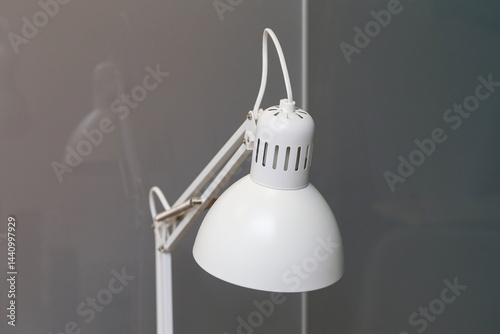 Obraz na płótnie Minimalist white desk lamp. Modern workspace accessory. Simple lighting design. Bright light source. Contemporary interior element. Clean and stylish desk lamp. Elegant home office decor. w salonie