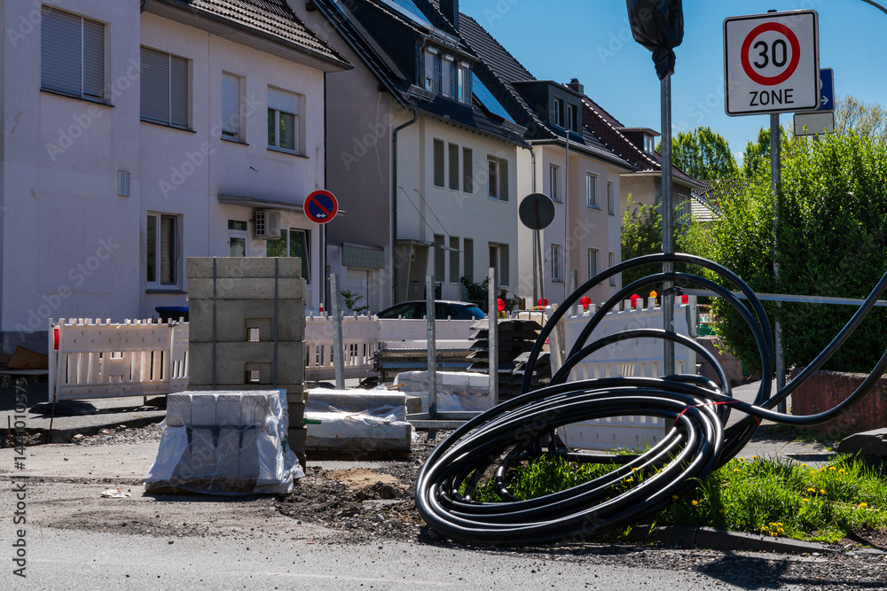 Fototapeta premium Building materials and utility cables were coiled on a city street