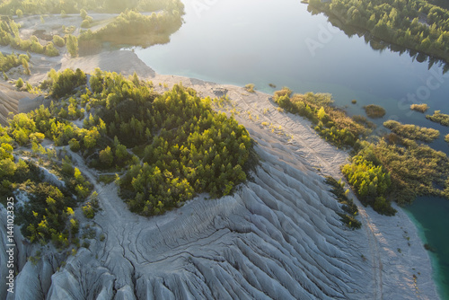 Wallpaper Mural Picturesque aerial view of a clear water lake in a former sand and limestone quarry with green trees illuminated by golden light. Torontodigital.ca