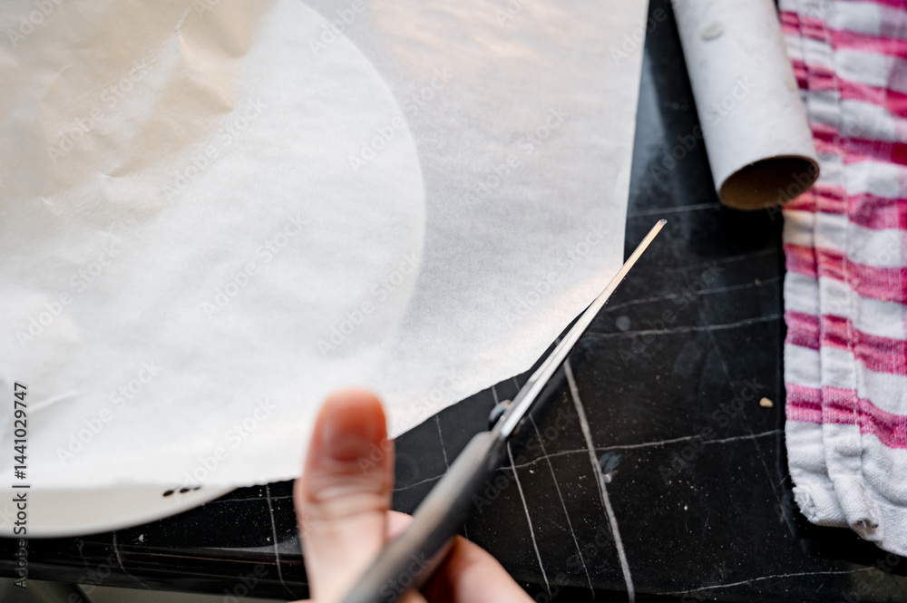 Preparing parchment for baking pizza, cutting parchment