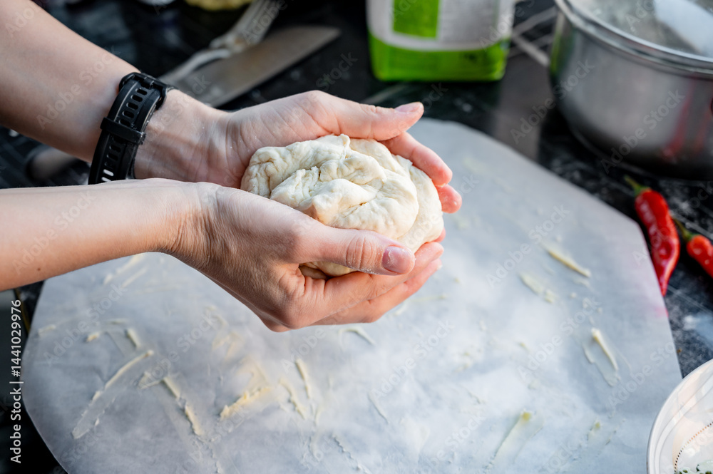 Homemade Pizza Preparation with Three Cheeses – Female Hands in Action. A warm, close-up scene of a woman’s hands preparing homemade pizza dough on a kitchen countertop. Photo recipe.
