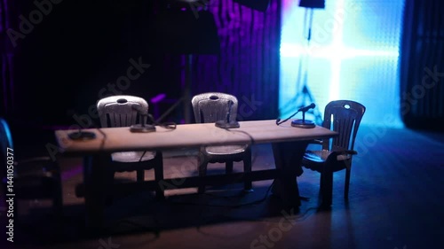 Podcast Studio Setup with Four Microphones and Cameras Ready for Recording. Miniature table top. Selective focus