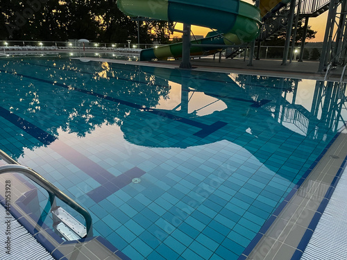 A beautiful view of the water park with colorful slides and a pool on a sunny day. The banner is ready.