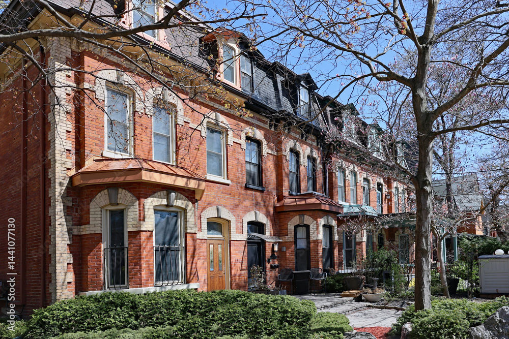 Fototapeta premium Row of well preserved 19th century houses with dormer windows and mansard roof
