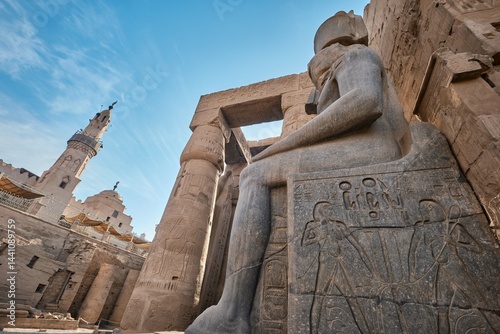 Luxor, Egypt - December 26 2023: Statue of Ramesses II and Mosque of Abu Haggagat at the Luxor Temple