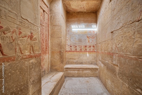 Saqqara, Egypt - January 2, 2024: Painted bas relief figures showing daily life in ancient Egypt inside Tomb of Kagemni in Saqqara necropolis