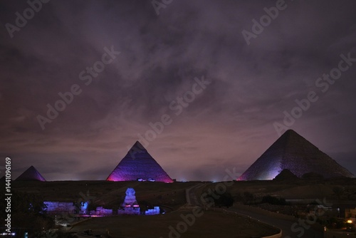 Giza, Egypt - December 24 2023: The Pyramids and the Sphinx in the night lights