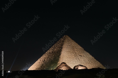 Giza, Egypt - December 24 2023: The Great Pyramid Khufu (Pyramid of Cheops) is the oldest and largest of the three pyramids in the Giza at night