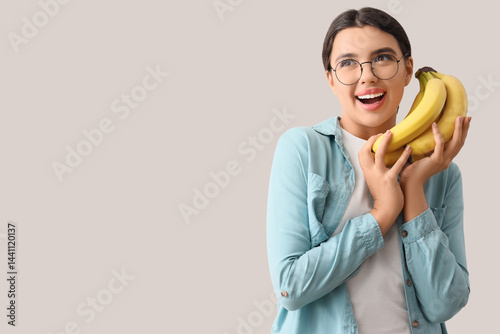 Happy young woman with bana...