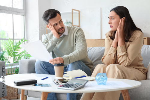Worried young couple with b...