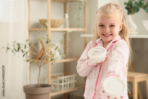 Cute little girl with jars ...