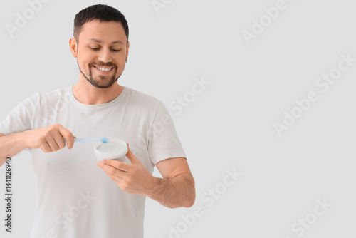 Young man with tooth powder...
