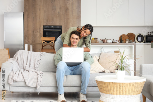 Young couple using laptop o...
