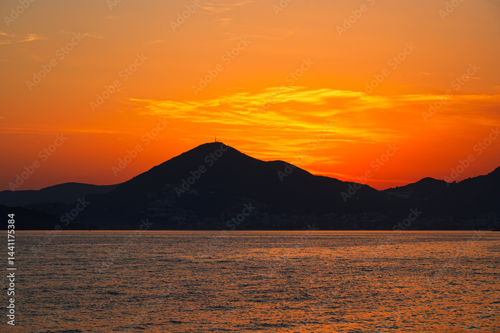 Sunset on Sveti Stefan Beach near Budva on the Montenegrin riviera, on the coast of the Adriatic Sea