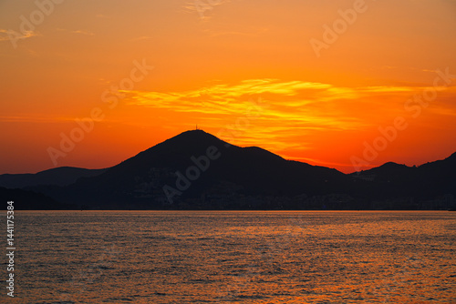 Obraz na płótnie Sunset on Sveti Stefan Beach near Budva on the Montenegrin riviera, on the coast of the Adriatic Sea w salonie