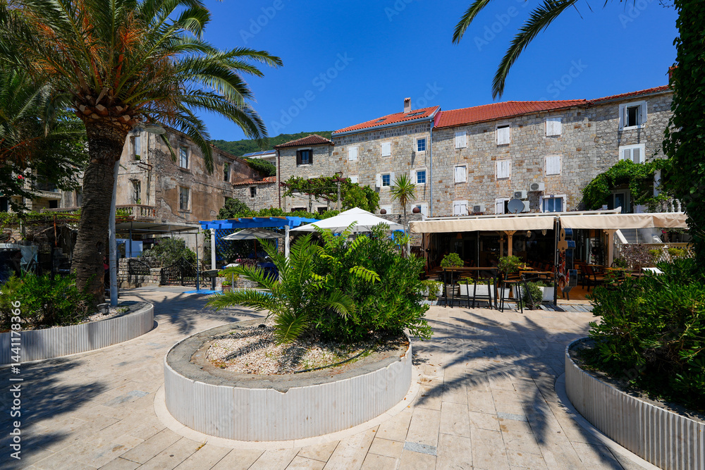 Old stone houses in Petrovac na Moru, a resort town located on the coast of the Adriatic Sea in Montenegro
