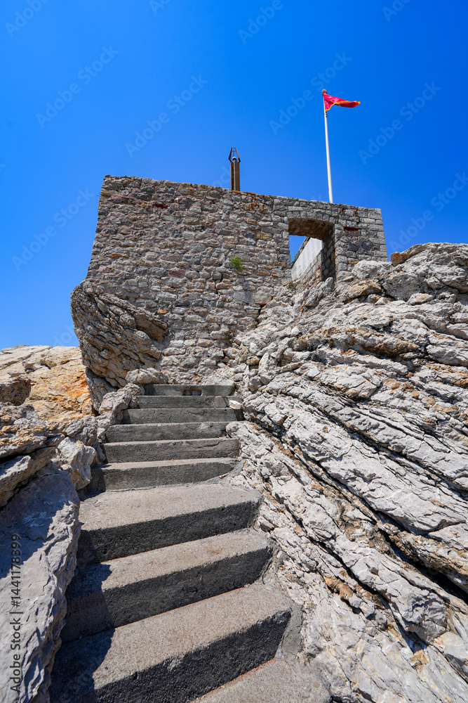 Kastio Castle built on a peninsula in Petrovac na Moru, a resort town located on the coast of the Adriatic Sea in Montenegro