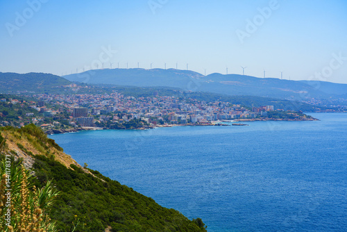 View of Dobra Voda and of Mali Pijesak Beach on the Montenegrin riviera along the coast of the Adriatic Sea - Možura wind farm on a seaside hilltop