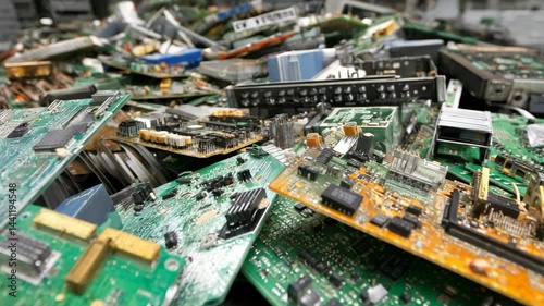 Electronic waste pile featuring obsolete circuit boards, integrated circuits, and components awaiting recycling or disposal.