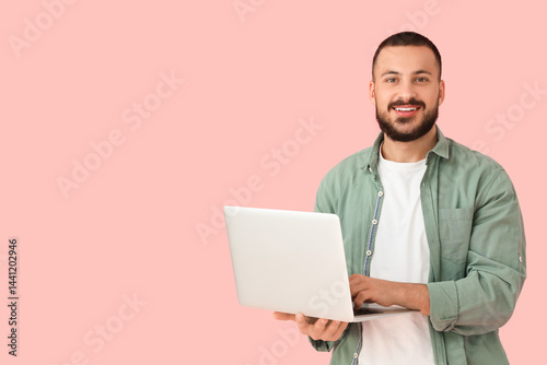 Young man with laptop on pi...