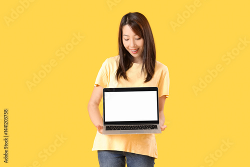 Young Asian woman with lapt...