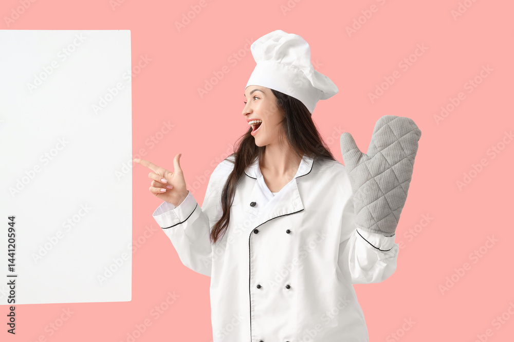 Beautiful chef with oven mitten pointing at blank poster on pink background Beautiful chef with oven mitten pointing at blank poster on pink background