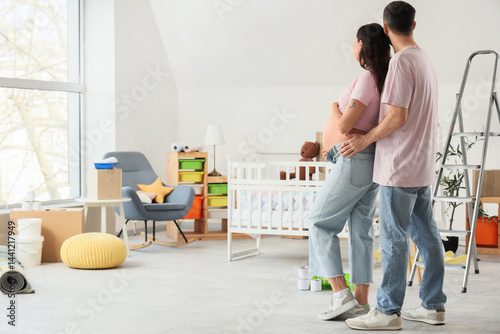 Young pregnant couple huggi...