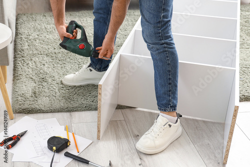 Man assembling white flat-p...