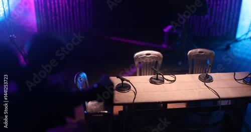 Podcast Studio Setup with Four Microphones and Cameras Ready for Recording. Miniature table top. Selective focus