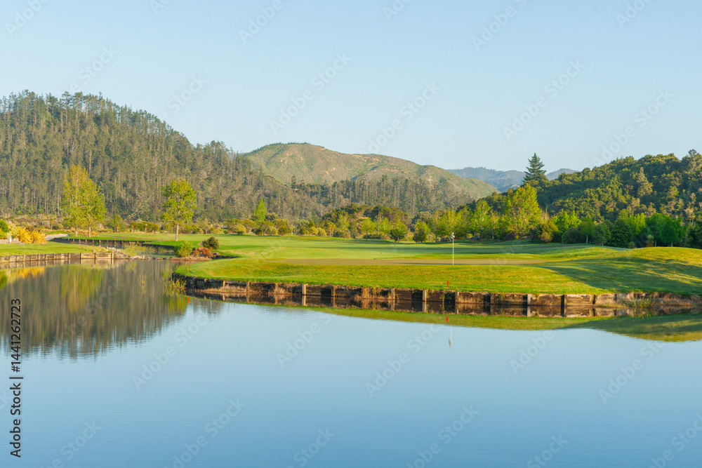waterway winding through landscape past golf course green