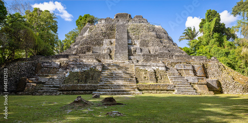 Majestic Mayan pyramid at Lamanai archaeological site in Belize. Ideal for travel ads, history blogs, educational content, tourism promotions, and cultural heritage publications. photo