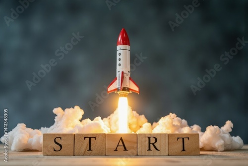 Motivational image of a rocket launching over wooden blocks spelling start.