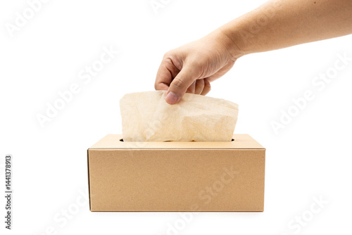 Hand taking Brown tissue paper box isolated on white background. Copy space for text. Nice natural cardboard box of paper tissue.