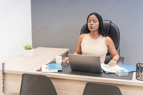 Manager practicing mindfulness meditation at work for work-life balance